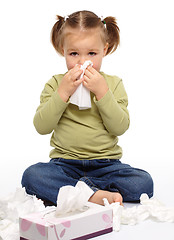 Image showing Little girl blows her nose