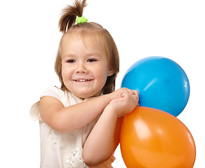 Image showing Cute little girl with two colored balloons