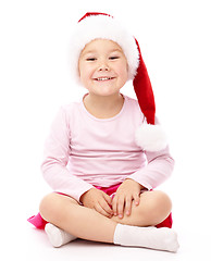 Image showing Little girl wearing red Christmas cap