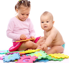 Image showing Little boy and girl are playing with alphabet