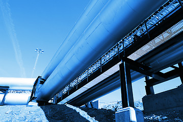 Image showing Industrial zone, Steel pipelines and valves against blue sky