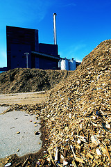 Image showing bio power plant with storage of wooden fuel against blue sky