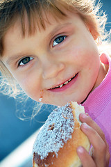 Image showing child eating a bun