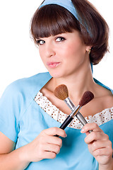 Image showing brunet woman with two make-up brushes 