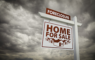 Image showing White Foreclosure Home For Sale Real Estate Sign Over Cloudy Sky