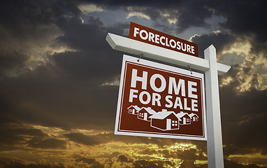 Image showing Red Foreclosure Home For Sale Real Estate Sign Over Sunset Sky