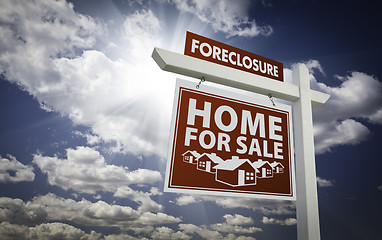 Image showing Red Foreclosure Home For Sale Real Estate Sign Over Clouds and S