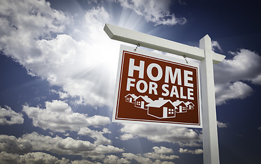 Image showing Red Home For Sale Real Estate Sign Over Clouds and Sky