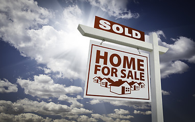 Image showing White Sold Home for Sale Real Estate Sign Over Clouds and Sky