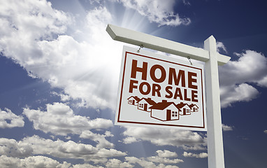 Image showing White Home For Sale Real Estate Sign Over Clouds and Sky