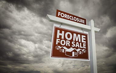 Image showing Red Foreclosure Home For Sale Real Estate Sign Over Cloudy Sky