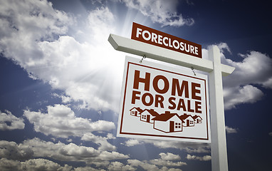 Image showing White Foreclosure Home For Sale Real Estate Sign Over Clouds and