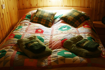 Image showing Colorful bed linen on a wooden bed