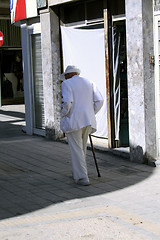 Image showing Old man getting into the shadow ...