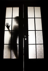 Image showing Girl behind the glass   