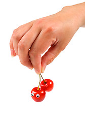 Image showing Hand holding two sweet cherry