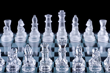 Image showing Macro shot of glass chess set against a black background