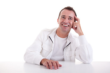 Image showing smiling middle-age man sitting at desk 