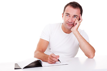 Image showing Portrait of a middle-age man thinking and writing, looking up