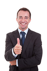 Image showing handsome businessman with thumb raised as a sign of success