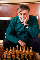 Image showing Senior man playing chess