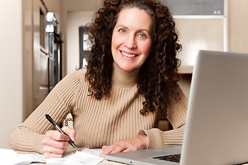 Image showing Woman paying bills