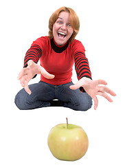 Image showing Woman stretch a hand to apple