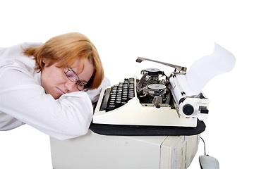 Image showing Woman sleeping on a workplace with a typewriter