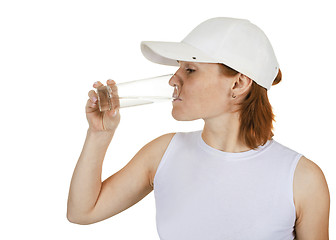 Image showing Girl in a cap and a water glass