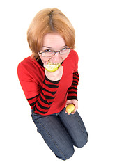 Image showing The girl eats an two apples