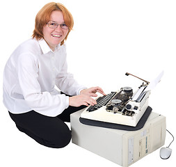 Image showing Girl printing on an typewriter