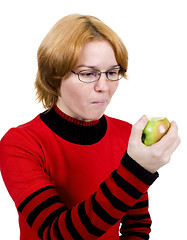 Image showing The girl eats an apple