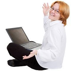 Image showing Woman sitting on a floor with the notebook on white