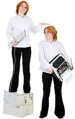 Image showing Girl with the computer keyboard, and girl with a typewriter