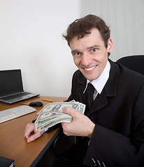 Image showing The man holds dollars