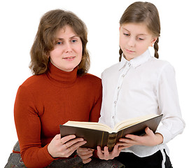 Image showing Woman and girl reads the book