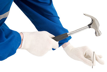 Image showing Male hand with hammer and nail