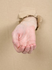 Image showing Male hand through in cardboard