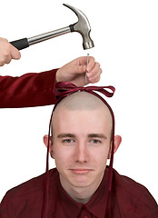 Image showing To the young man hammer a bow to a head