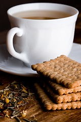 Image showing cup of herbal tea and some fresh cookies