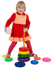 Image showing Small girl and toy plastic pyramid