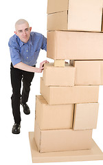 Image showing Man pushing heap from cardboard boxes