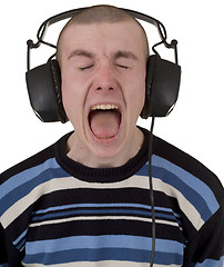 Image showing Young man in earphones loudly sings