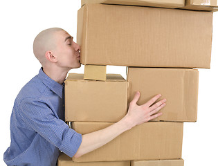 Image showing Man kisses heap cardboard boxes