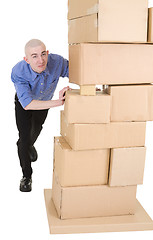 Image showing Man pushing heap from cardboard boxes