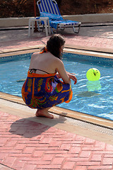 Image showing Girl next to blue swimming pool ...