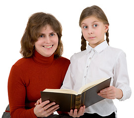 Image showing Woman with girl reading book