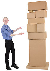 Image showing Man showing on pile cardboard boxes