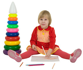 Image showing Little girl and crayons and toy pyramid