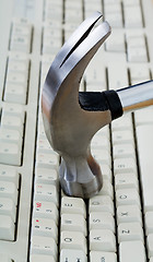 Image showing Metal hammer on keyboard